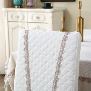 Quilted dining chair cover with elegant lace trim, retro European style home decor piece.