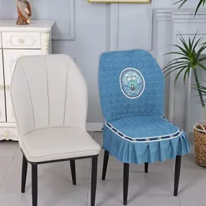 Blue quilted elastic dining chair cover with exquisite floral embroidery and ruffles.