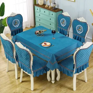 Detailed view of luxury blue velvet dining table cloth and matching embroidered chair covers.