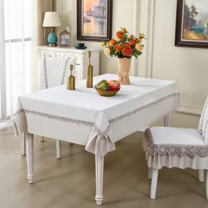 Elegant beige dining chair cover and tablecloth set with delicate lace trim detailing.