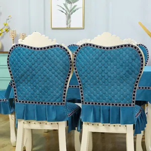 Detailed shot of elegant blue quilted dining chair cover with refined decorative borders and ruffles.