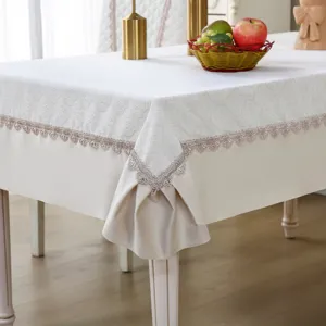 Elegant white lace tablecloth with delicate pleated edge for dining table detail decoration.