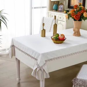 Elegant white jacquard dining tablecloth and matching chair cover set for home decoration.