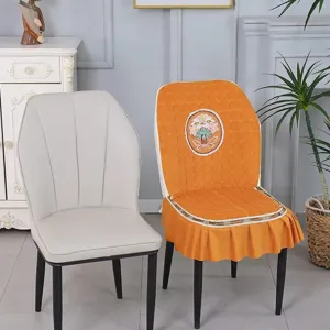 Detailed close-up of the quilted elastic dining chair cover featuring cute flower embroidery and skirt.