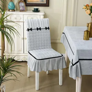 Detailed close-up view of the grey patterned dining chair cover and matching tablecloth.