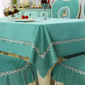 Detailed view of European style green tablecloth and chair cushion set with delicate lace trim.