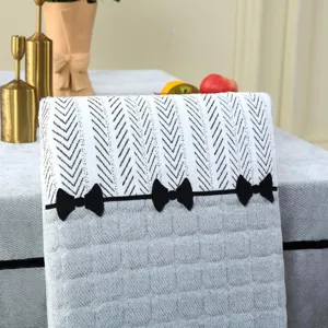 Knitted dining chair cover detail with chevron top, quilted grey base and bow decor.
