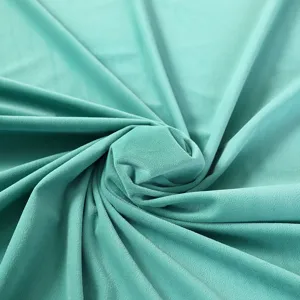 Mint green velvet fabric material, soft plush texture for home decor upholstery sewing.