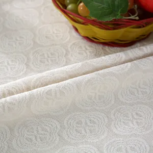 Close-up detail of beige jacquard fabric texture for chair cover home textile product display.