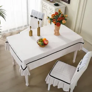Elegant dining table cloth and chair cover set with bowknot trim for home decor and protection.