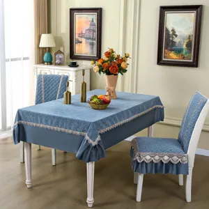 Elegant blue dining chair cover and tablecloth set with delicate lace trim for home decor.