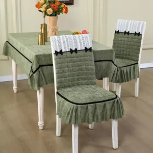 Detailed view of elegant green quilted dining chair cover and matching tablecloth set with cute bows.