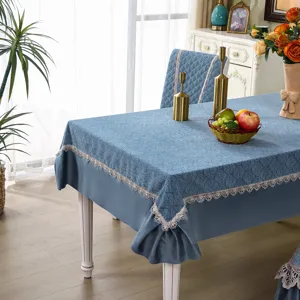 Blue jacquard tablecloth and dining chair cover detail, elegant lace trim interior decor setup.