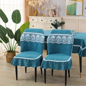 Blue quilted dining chair cover with elegant white lace floral trim and ruffled skirt.