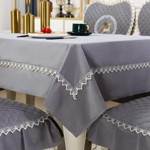 Detail shot of grey tablecloth and chair cover with elegant lace trim and deer embroidery.