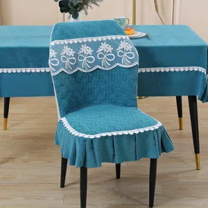 Detailed view of turquoise quilted dining chair cover featuring elegant white lace floral trim.