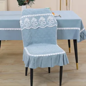 Light blue quilted chair cover detail, elegant white lace floral trim for dining room decor.