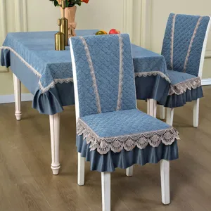 Blue quilted dining chair cover and tablecloth set with elegant lace trim for home decor.