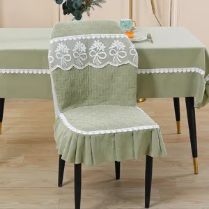 Green quilted dining chair cover and tablecloth set with delicate white lace floral trim.