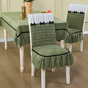 Universal dining chair cover set with matching tablecloth, quilted green fabric and bows.