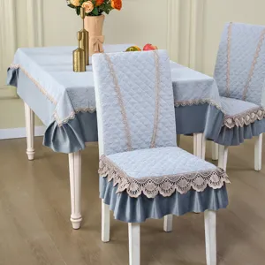 Elegant quilted dining chair cover and tablecloth set with delicate lace and ruffle.