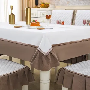 Elegant tablecloth and chair cover set with brown ruffles, perfect for dining room decor.