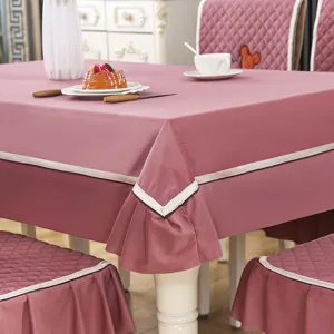 Pink dining table cloth and quilted chair covers set with elegant trim details and cozy home style.