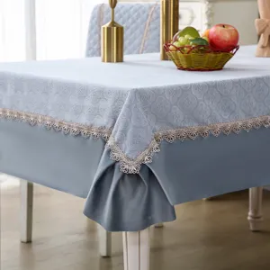 Elegant light blue tablecloth and chair cover set with delicate lace trim for dining room decor.