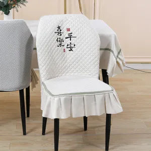 Detailed view of the quilted dining chair cover with Chinese calligraphy embroidery and trim.