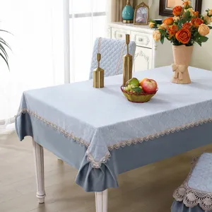 Elegant light blue dining chair cover and tablecloth set featuring delicate lace trim.