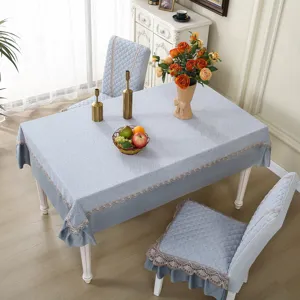 Dining table cloth and integrated chair cover set with elegant lace trim and embossed pattern.