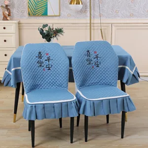Blue quilted dining chair cover set with elegant skirt, embroidered peaceful design decor.