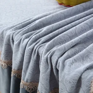 Close-up view of grey embossed chair cover fabric with delicate lace trim detail.