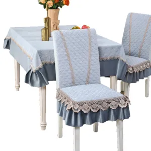 Light blue quilted dining chair cover and tablecloth set with elegant lace and ruffles.