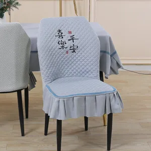Quilted elastic dining chair cover with embroidered Chinese characters and elegant skirt trim detail.
