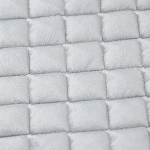 Italian velvet chair cushion fabric close-up, soft grid quilted texture for home decor.