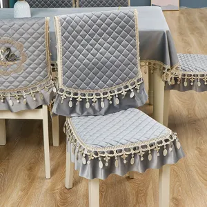 Italian velvet dining chair cover set with elegant lace trim and matching tablecloth.