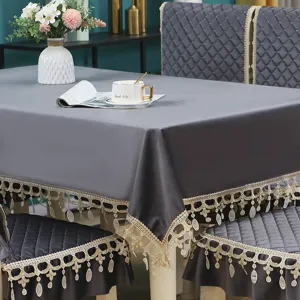 Grey velvet tablecloth and dining chair cushion set with elegant lace fringe for home decor.