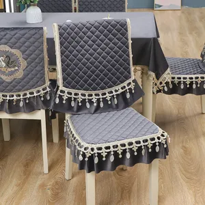 Grey velvet dining chair cover set with elegant lace trim and quilted design for home decor.