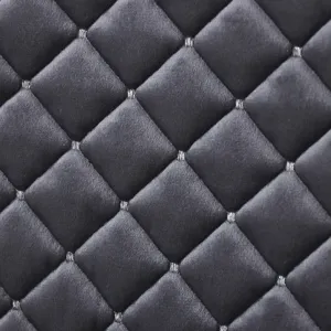 Detailed view of the Italian velvet quilted chair cushion fabric texture and pattern.