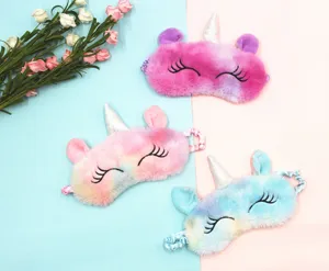 Three colorful plush unicorn sleep masks with soft gradient fur and silver horns.