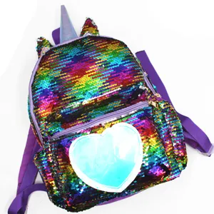 Detailed view of the rainbow sequin unicorn backpack with a light blue heart patch