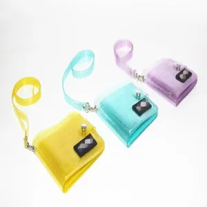 Transparent glitter PVC neck wallet in three vibrant colors: yellow, teal, and purple.
