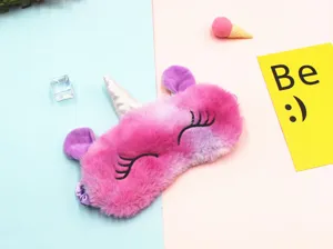 Close-up detail of a soft gradient plush unicorn eye mask with embroidered lashes