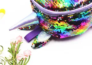 Detailed macro shot of vibrant reversible sequins and horn on unicorn school backpack