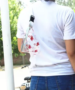 Detailed view of a transparent PVC fanny pack featuring a stylish red flamingo print.