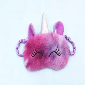 Soft plush unicorn sleep mask with gradient purple fur and glittery horn detail.