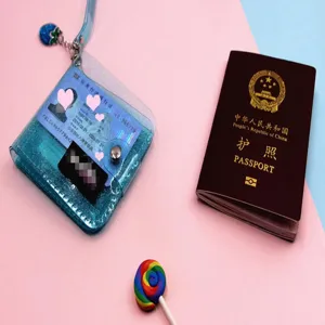 Detailed view of a glittery teal transparent PVC ID card holder with a matching strap