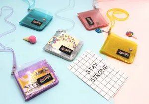 Close-up of colorful glitter PVC neck wallets with transparent straps and metal buttons