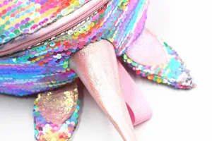 Close-up of sparkling rainbow sequins and pearlescent horn on unicorn backpack detail